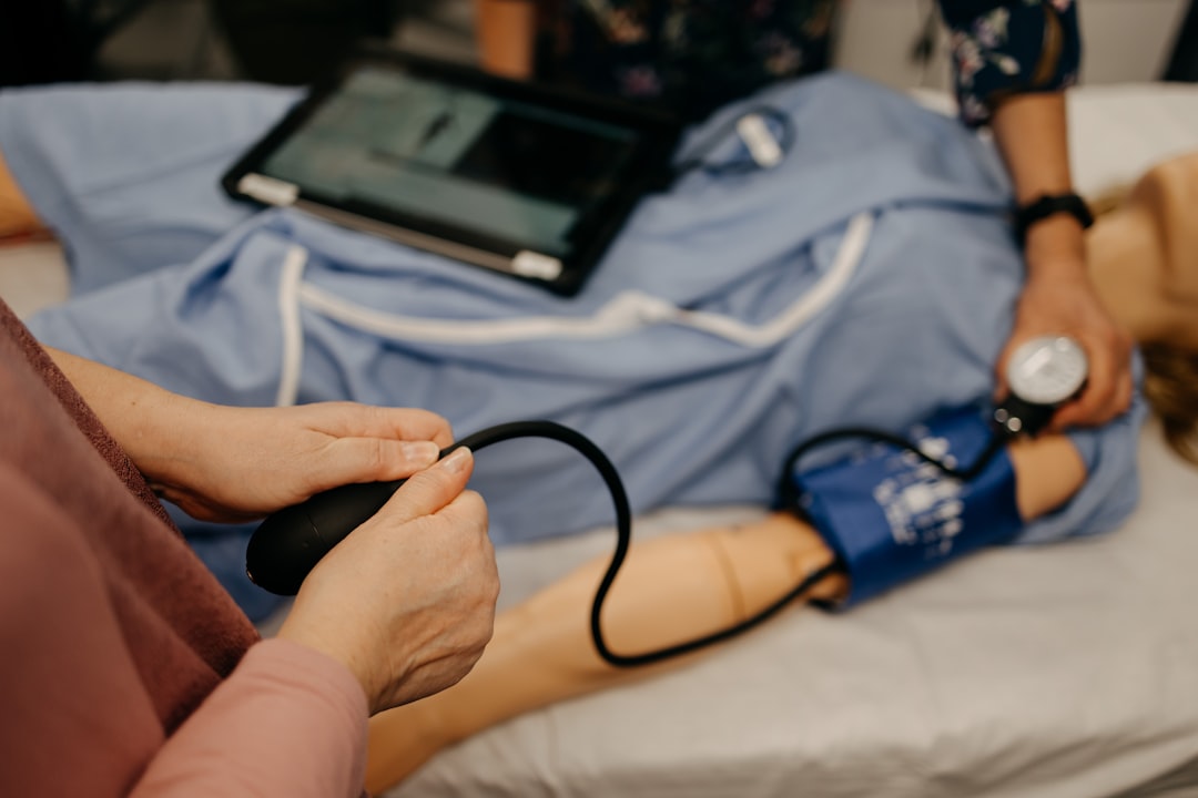 Medical professional conducting a preliminary physical examination, a component of a comprehensive PEAR assessment for federal personnel readiness.